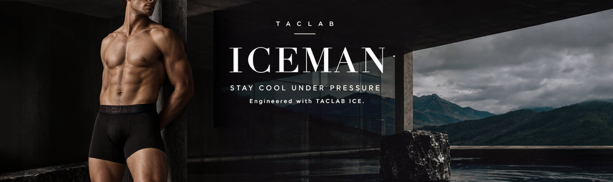 A muscular man wearing black Taclab Iceman men's briefs stands against a dark pillar in a dimly lit setting, with a scenic mountain view visible through a window in the background. The brand name 'TACLAB' and product name 'ICEMAN' are displayed in large white text on the right side.