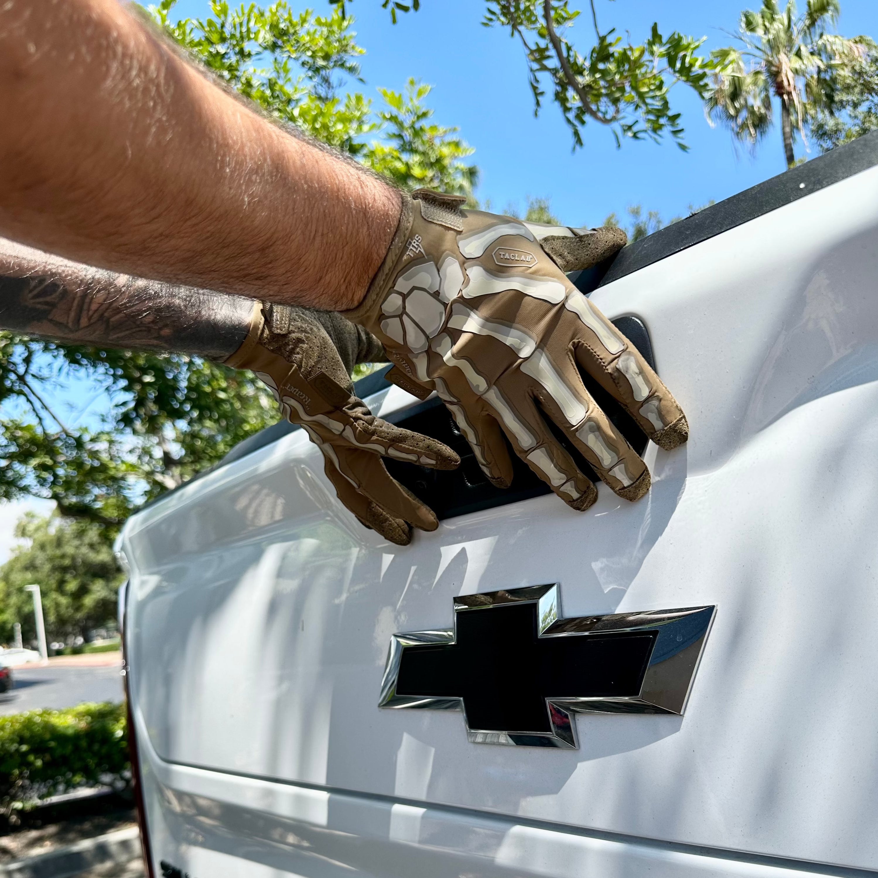 TACLAB REAPER Tactical Skeleton Gloves Showcasing Use Opening the Tailgate of a Truck